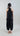 Back view of Psophía asymmetric top with embroidered floral motifs and subtle drape.