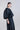 Side view of the lightweight jacket, highlighting bishop sleeve volume and fluid, minimalist silhouette.