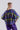 Back view of the Retro Prism blouse with cropped shape, flowing fabric and energetic geometric pattern.