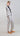 Cropped double pinstripe blazer shown from the side, highlighting straight sleeves and refined tailoring.