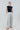 Double pinstripe high-waist wide-leg pants shown from the front, highlighting pleats and precise tailoring