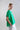 Side view of drawstring side-gathered mercerized cotton T-shirt highlighting short sleeves, adjustable side gathers, and fluid silhouette.