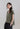 Side view of low shoulder mercerized cotton V-neck T-shirt highlighting side slits and softly gathered hem.