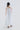Back view of the muted peony fluid dress highlighting wide straps and flowing silhouette.