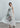 Women’s muted peony print fluid dress styled in relaxed silhouette with handkerchief hem and soft movement