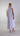 Back view of sleeveless mercerized cotton midi dress with minimalist lines and refined structure.