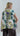 Back view of a printed sleeveless cotton blouse with epaulettes showing its soft drape and slightly extended hem.